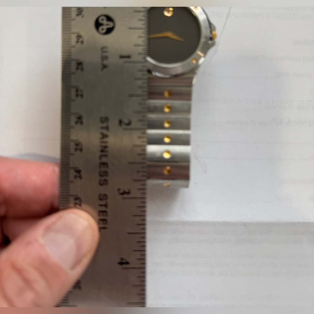 Movado Men’s Watch.  Stainless Steel with Gold Colored Trim.